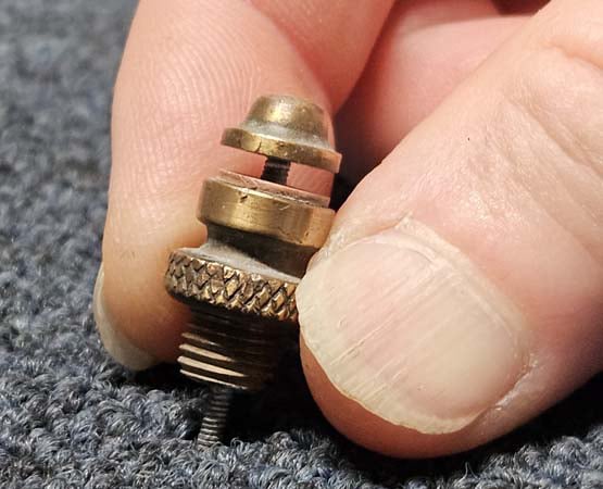 Pushing a safety valve against a table to check if the spring is working.