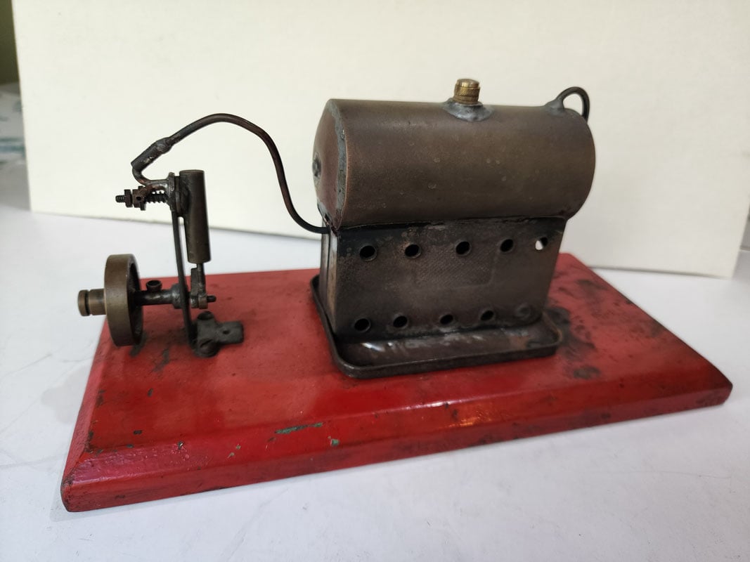 Radford model steam engine on red base